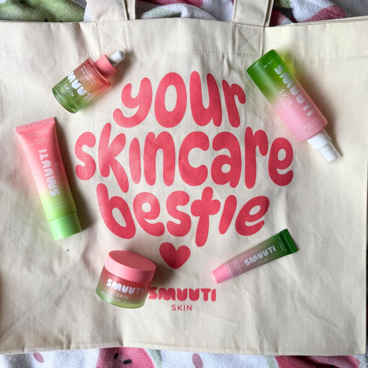 Tote bag with 'your skincare bestie' text and Smuuti skincare products on a watermelon-themed background
